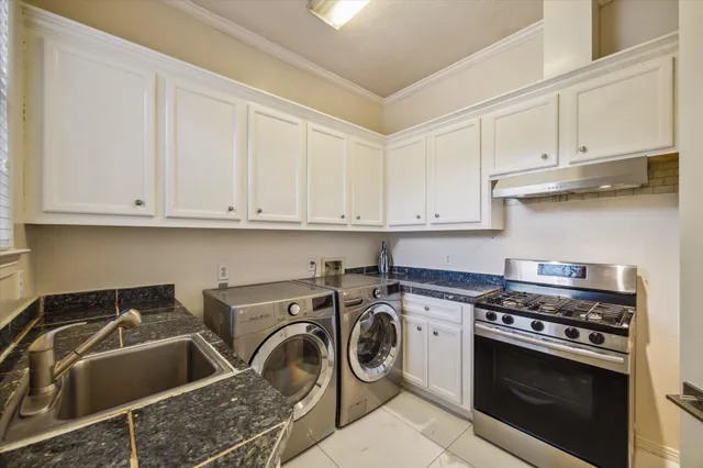 a kitchen with white cabinets and white appliances