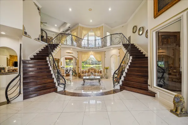 a view of entryway and hall with wooden floor
