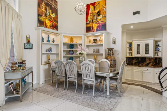a dining area with furniture and a kitchen