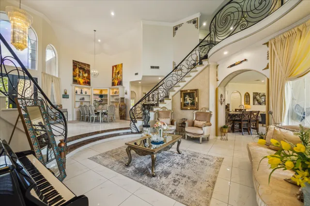 a living room with couches and dining table with wooden floor