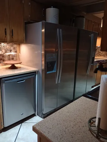 a kitchen with a refrigerator and a sink