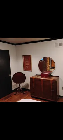 a living room with furniture and a lamp