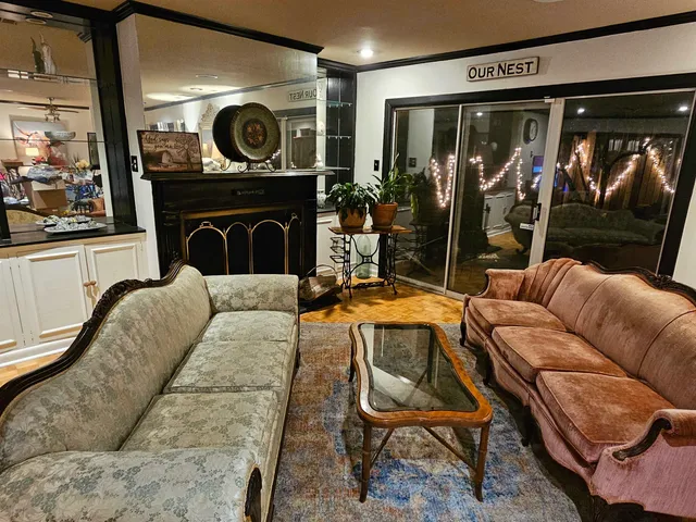a living room with furniture a flat screen tv and a fireplace