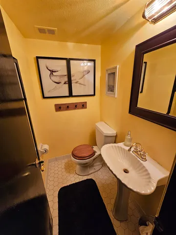 a bathroom with a sink mirror vanity and toilet