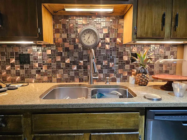 a sink and a stove top oven sitting on a shelf