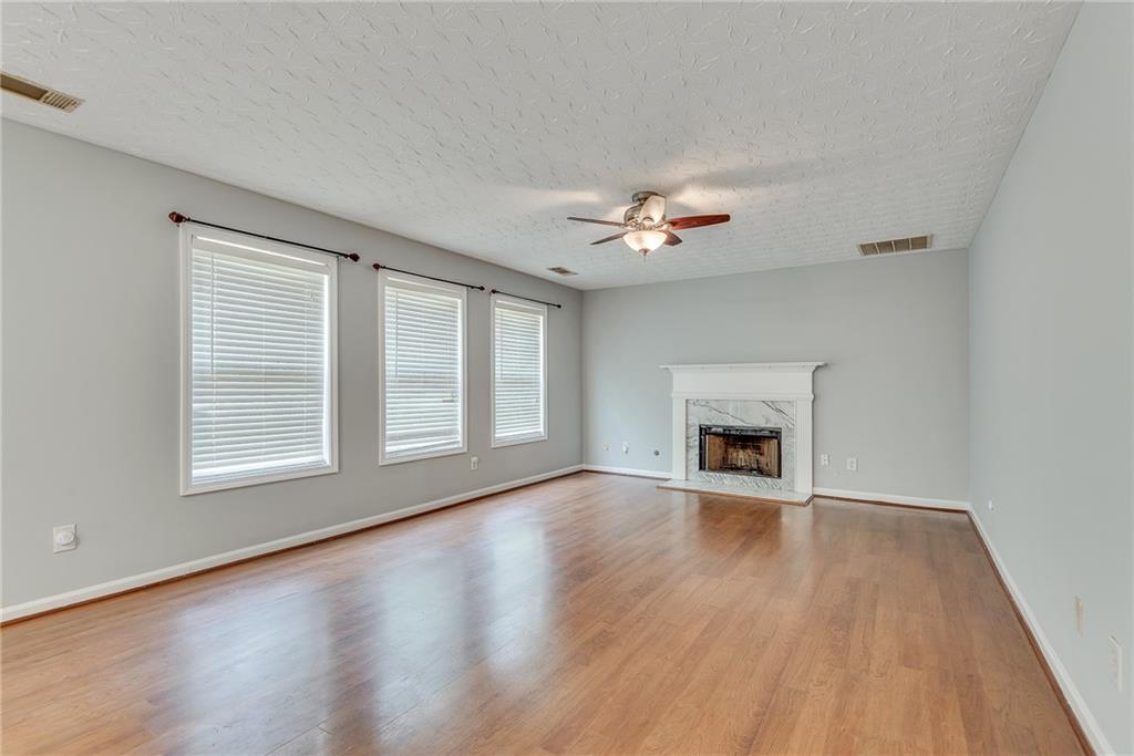 3337 Baymount Way Lawrenceville, GA 30043 - Photo 19 of 47 a view of an empty room with chandelier and fireplace