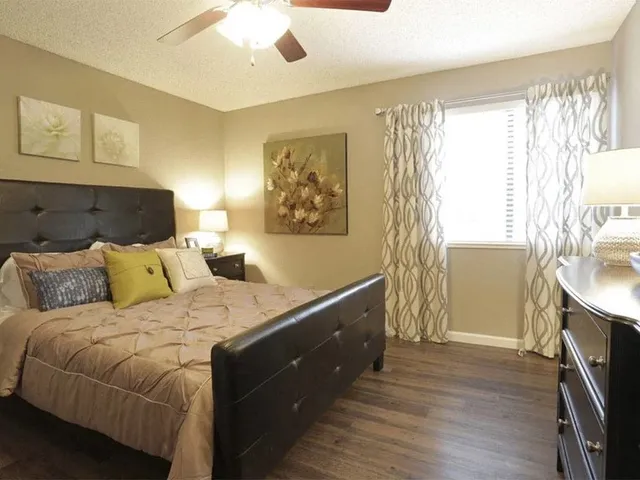 a view of a room with wooden floor and fan