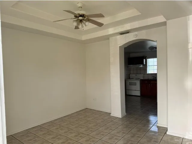 a view of a hallway to a livingroom and a kitchen