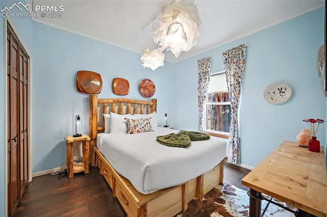 a bedroom with a table and a chandelier