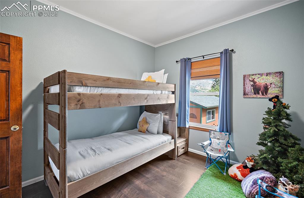 9845 Mesa Road Cascade, CO 80809 - Photo 17 of 50 a bedroom with a bed and a window