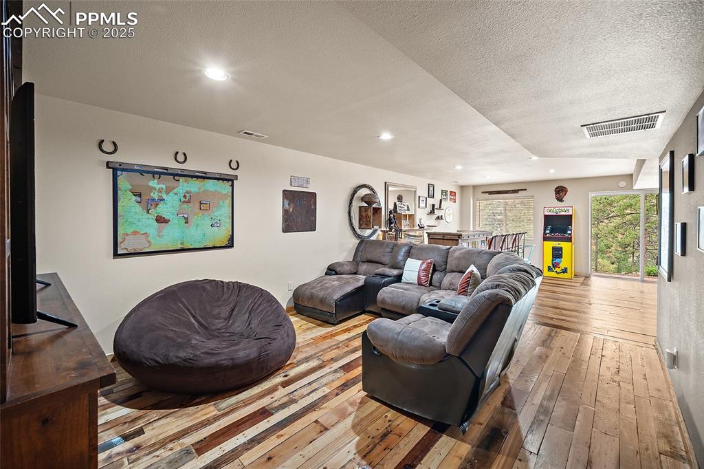 9845 Mesa Road Cascade, CO 80809 - Photo 23 of 50 a living room with furniture and a wooden floor