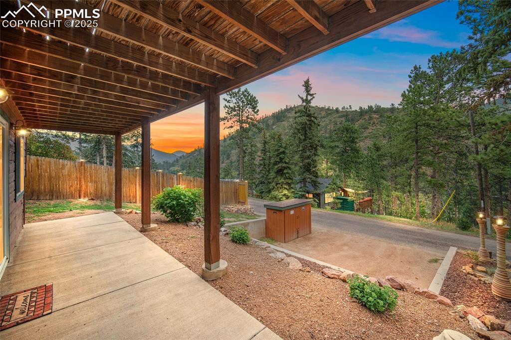 9845 Mesa Road Cascade, CO 80809 - Photo 24 of 50 a backyard of a house with fountain and outdoor seating