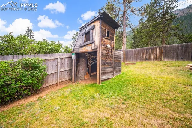 a view of a house with a yard and sitting area