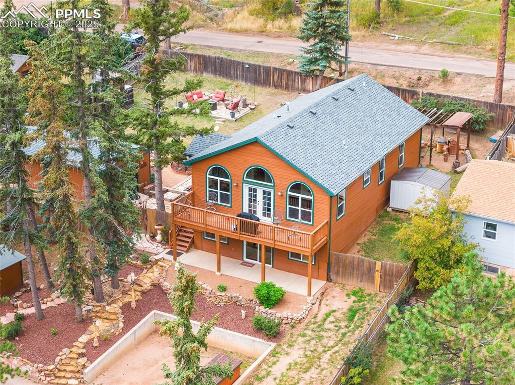 9845 Mesa Road Cascade, CO 80809 - Photo 43 of 50 a backyard of a house with wooden fence and large trees