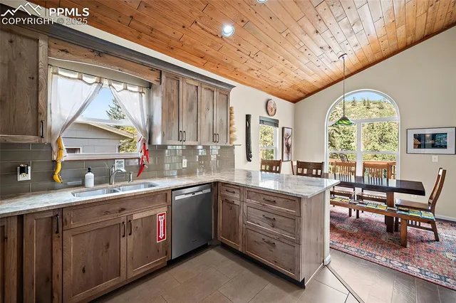 a kitchen with a sink window and cabinets