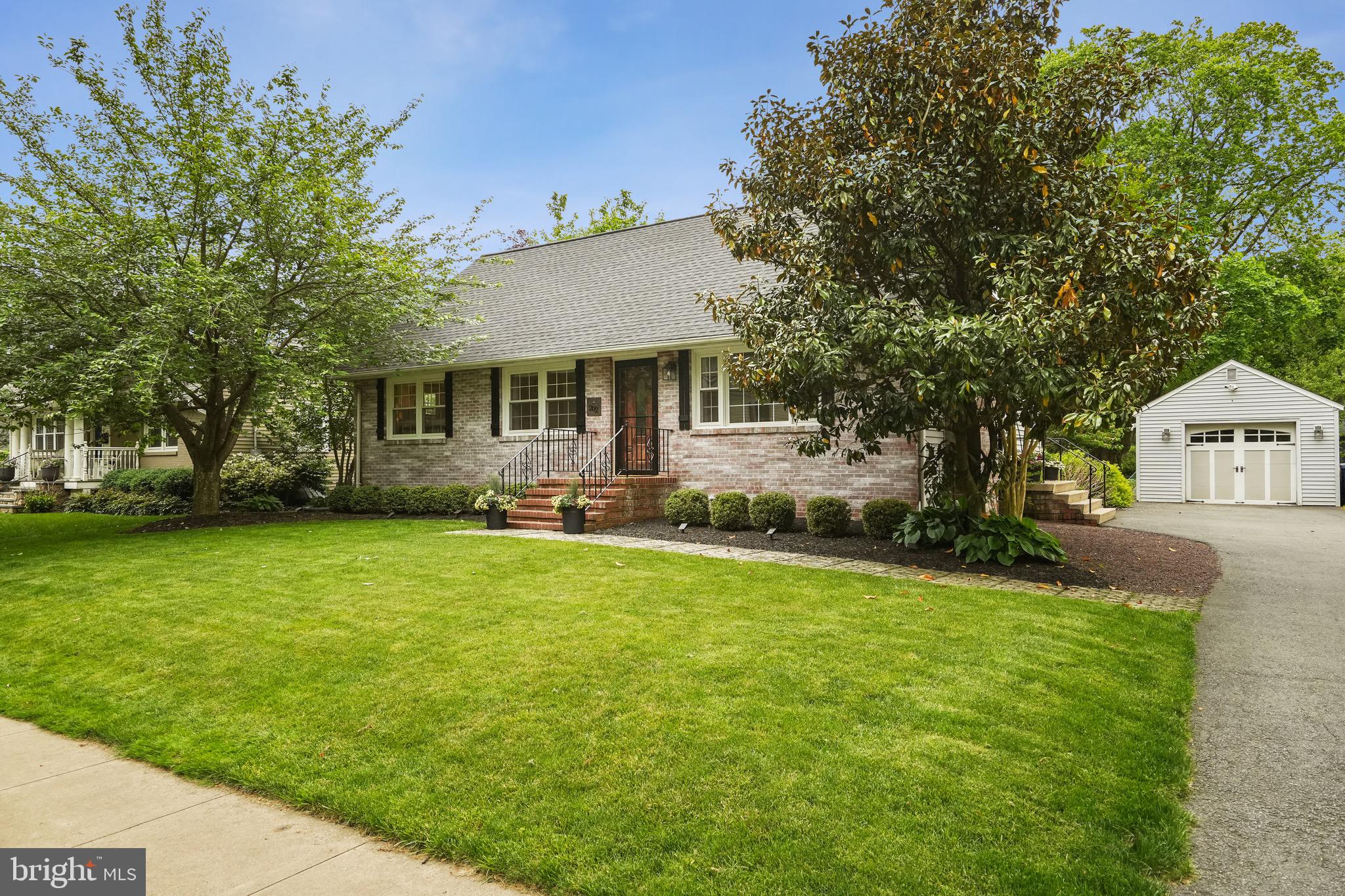 a front view of house with yard and trees