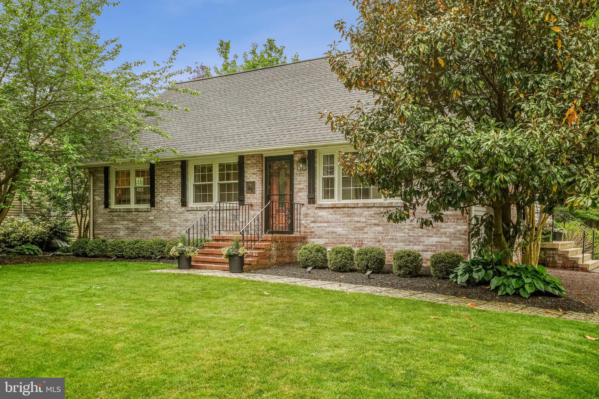 202 Burd Street Pennington, NJ 08534 - Photo 2 of 30 a front view of a house with a garden and yard