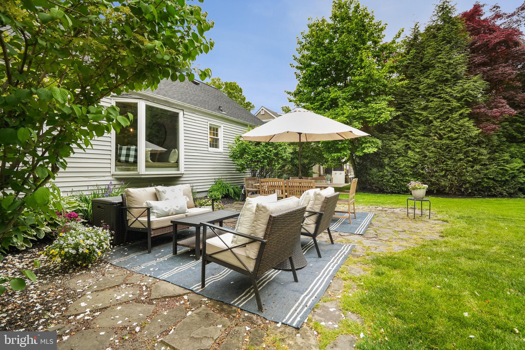 202 Burd Street Pennington, NJ 08534 - Photo 26 of 30 a view of a patio with table and chairs under an umbrella