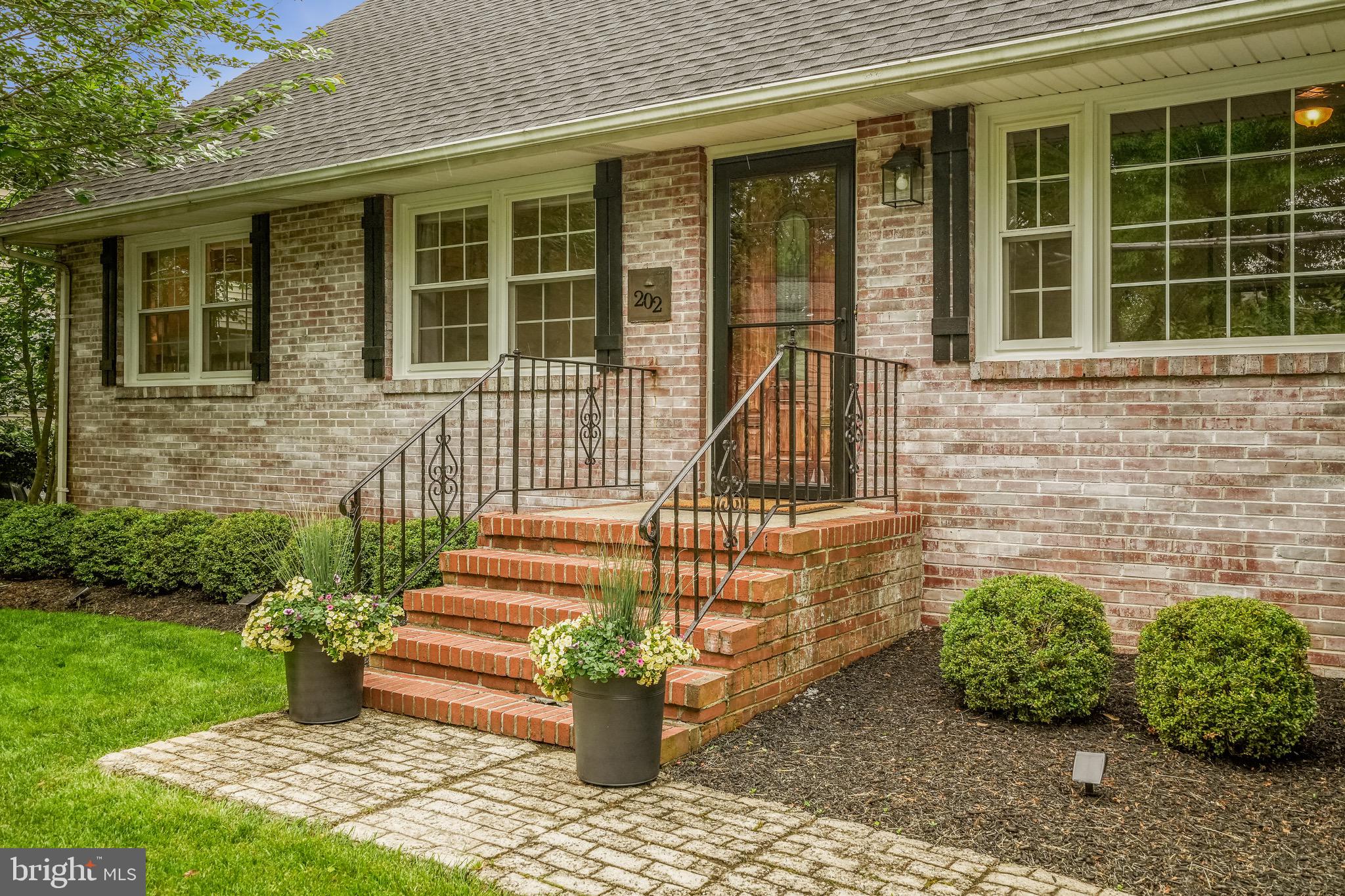 202 Burd Street Pennington, NJ 08534 - Photo 5 of 30 a front view of a house with a garden