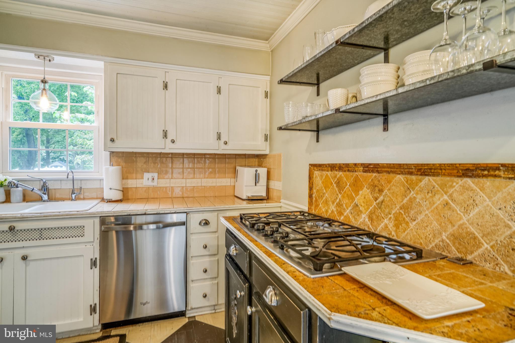 202 Burd Street Pennington, NJ 08534 - Photo 10 of 30 a kitchen with granite countertop a stove and white cabinets