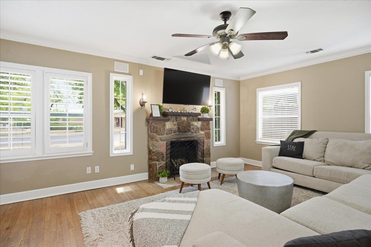 2702 20th Street Lubbock, TX 79410 - Photo 4 of 34 a living room with furniture a flat screen tv and a fireplace