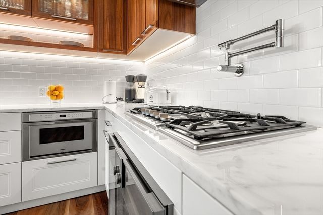 a stove top oven sitting inside of a kitchen