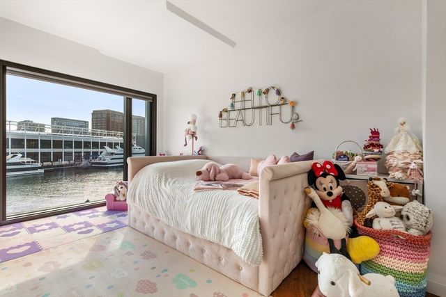 a bedroom with two beds and a painting on the wall