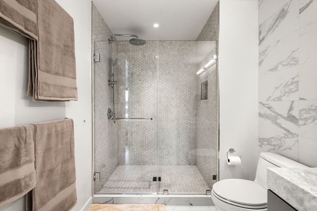 a bathroom with a toilet and a shower