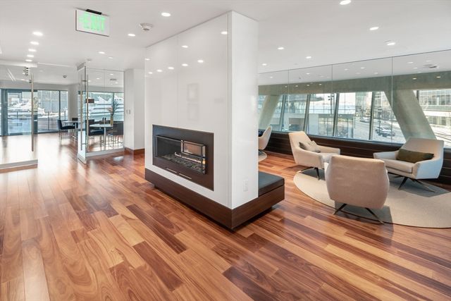 a living room with furniture wooden floor and a fireplace