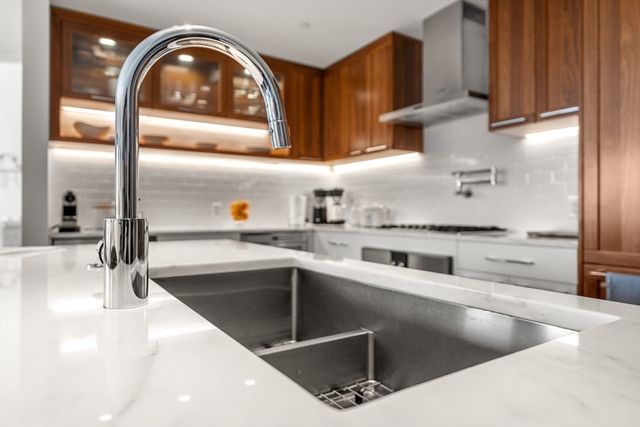 a kitchen with a sink a counter top and stainless steel appliances