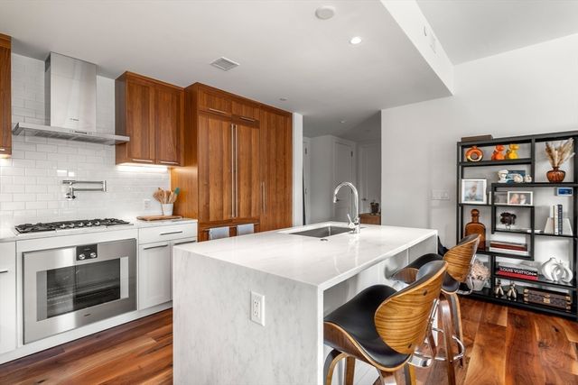 a kitchen that has a table and chairs in it
