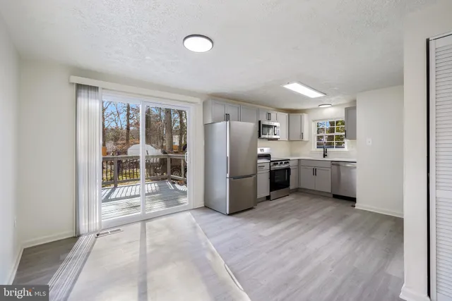 a kitchen with stainless steel appliances a refrigerator and a stove top oven