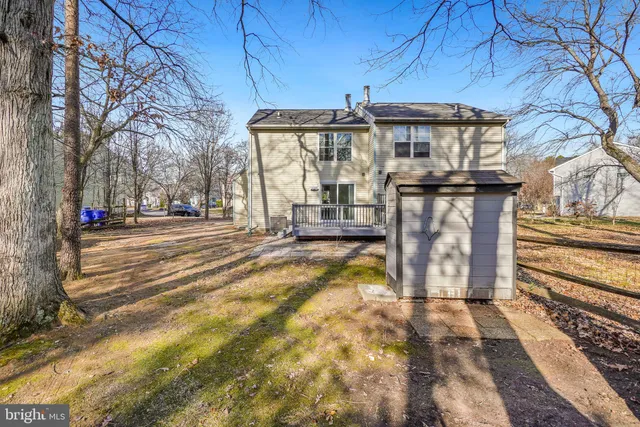 a view of a wooden deck with large trees
