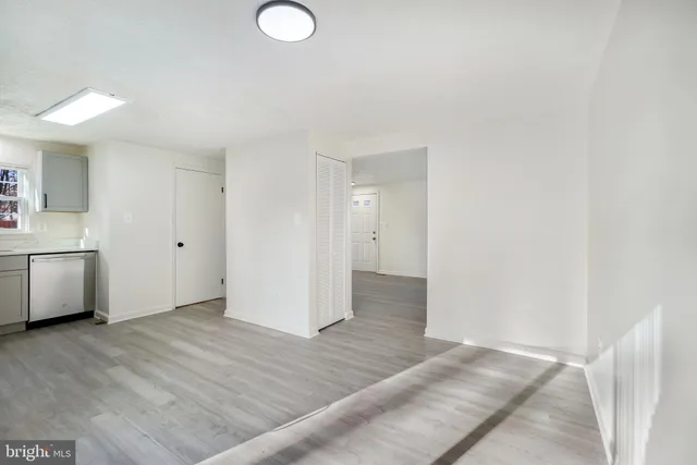 a view of a kitchen with wooden floor and electronic appliances