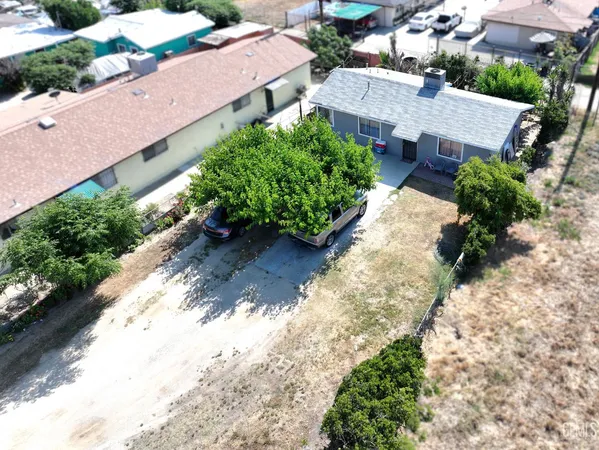 an aerial view of a house with a yard