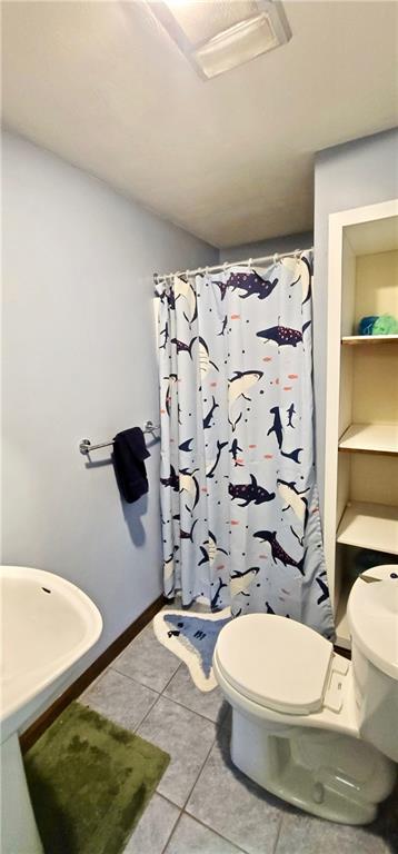 1535 Martin Road Tarentum, PA 15084 - Photo 11 of 25 a bathroom with a toilet and a shower curtain