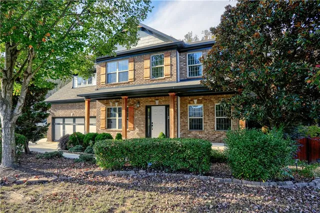 a front view of a house with garden