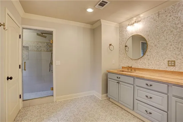 a bathroom with a double vanity sink mirror and shower