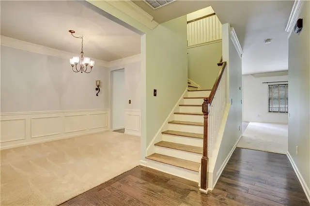 a view of a room with wooden floor and staircase