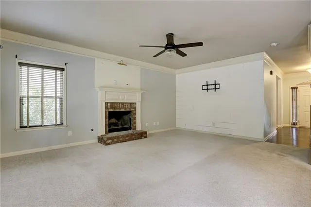 a view of a livingroom with a fireplace and window