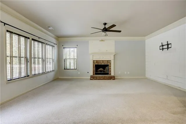 wooden floor fireplace and windows in an empty room
