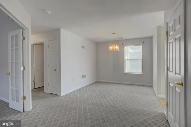 a living room with stainless steel appliances granite countertop furniture and a kitchen view