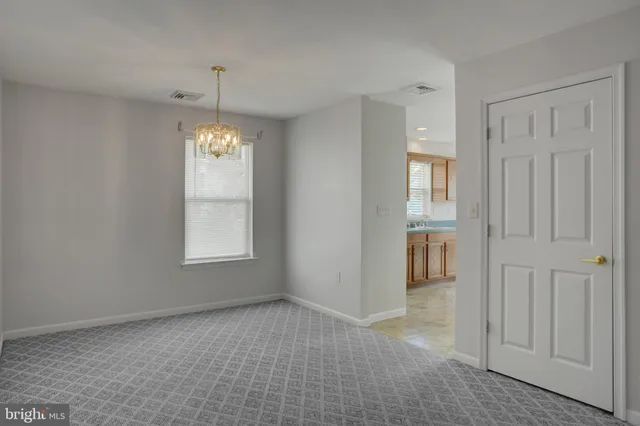 a kitchen with granite countertop a sink stove and cabinets