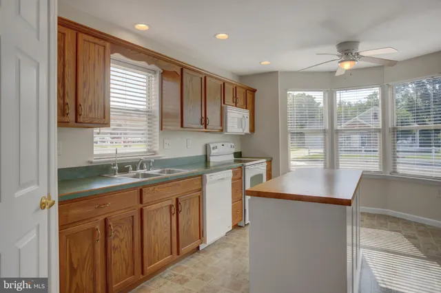a kitchen with stainless steel appliances granite countertop a refrigerator sink and cabinets