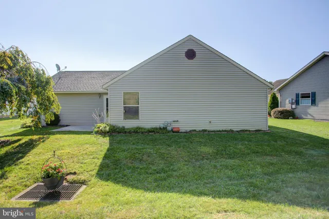 a view of a road with a building and trees in the background