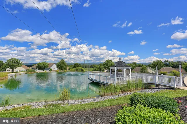 a view of a roof deck with chair and wooden floor