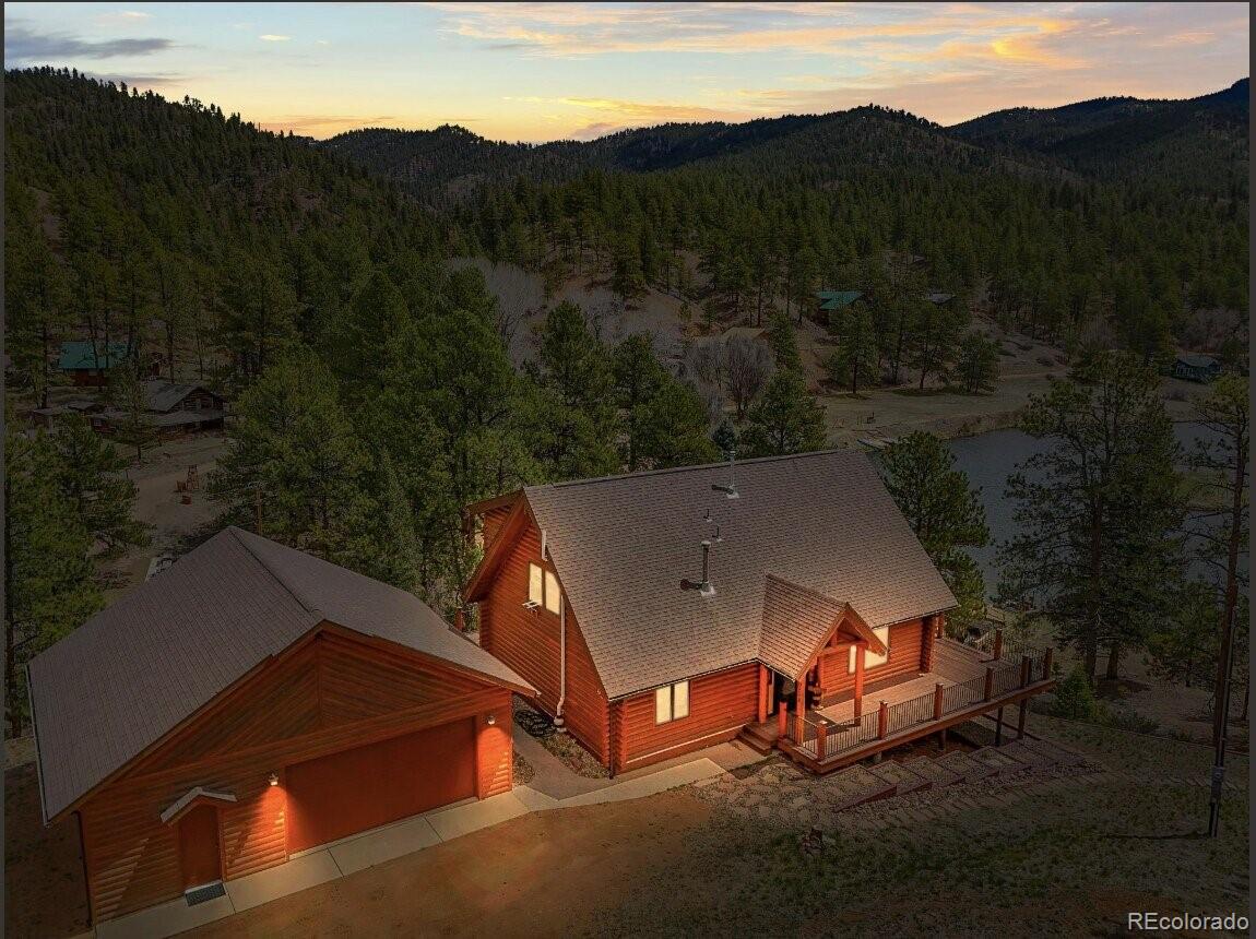 an aerial view of a house with mountain view