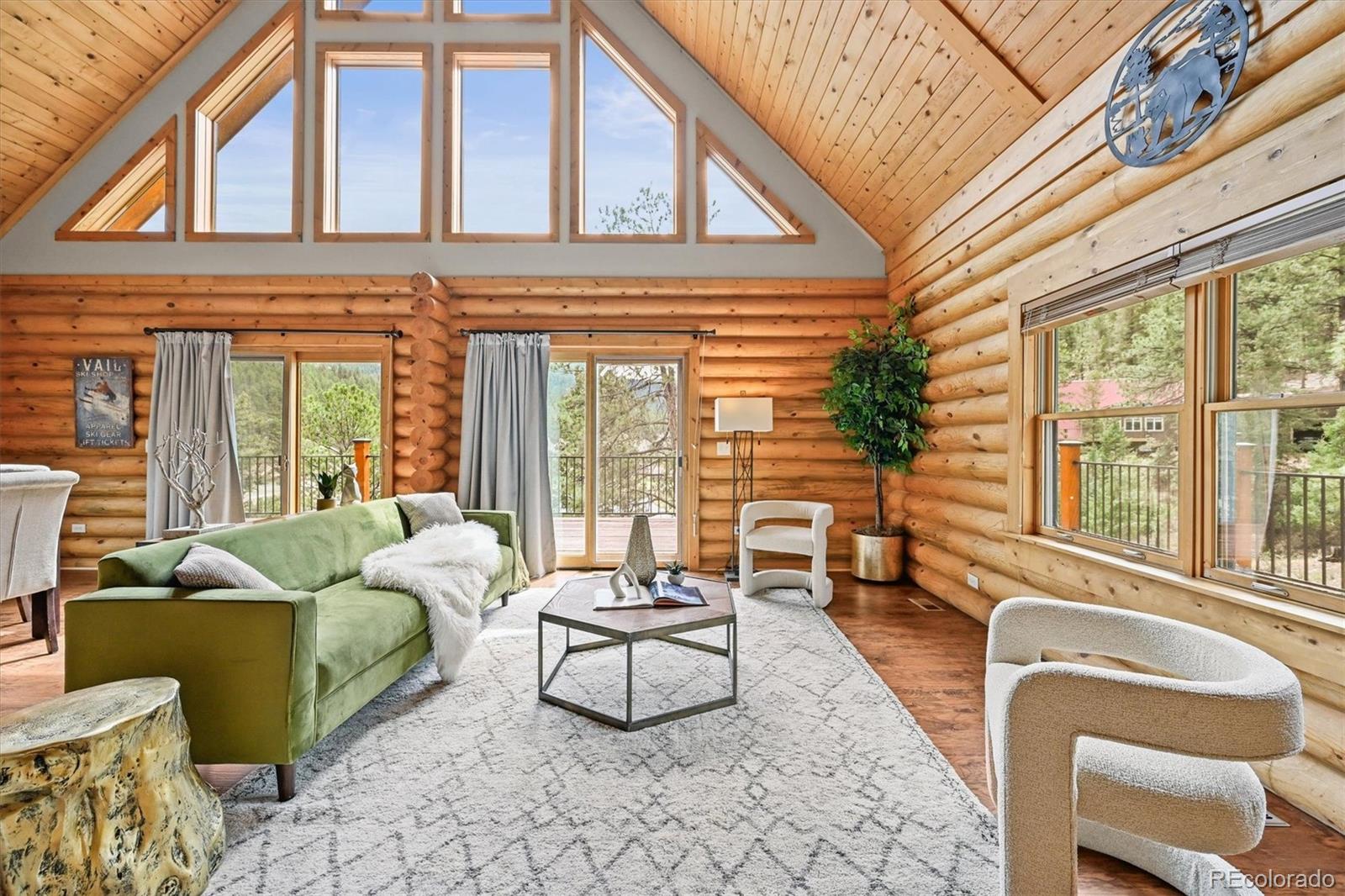 9868 South Overlook Road Sedalia, CO 80135 - Photo 19 of 50 a living room with furniture and floor to ceiling windows