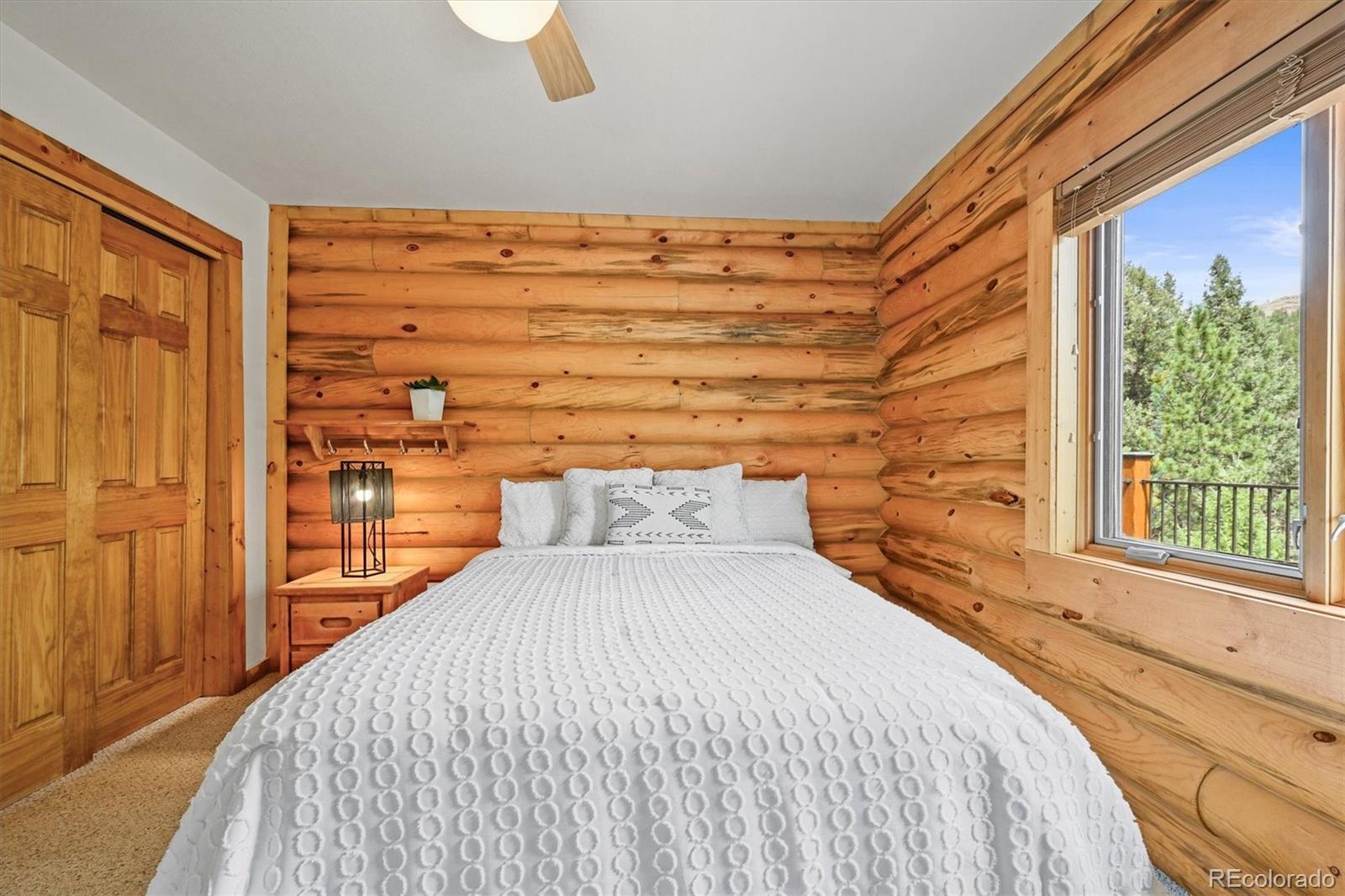 9868 South Overlook Road Sedalia, CO 80135 - Photo 32 of 50 a bedroom with a bed and a window