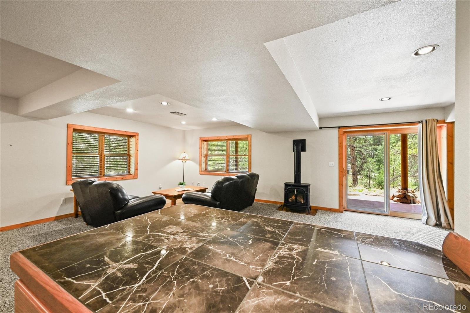 9868 South Overlook Road Sedalia, CO 80135 - Photo 44 of 50 a bedroom with a bed and wooden floor